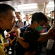 Subway personnel try to prevent a protester from blocking the door of a train as protesters disrupt services at Fortress Hill station in Hong Kong, Aug. 5, 2019.